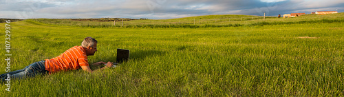 Man at work in the meadow at sunset