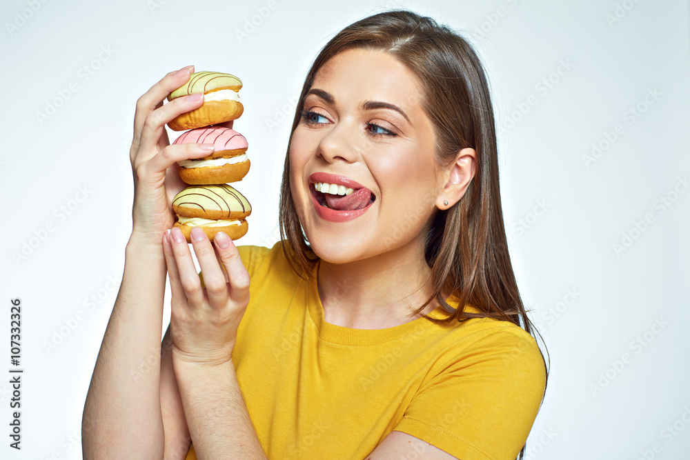 Young woman holding pile cake and licked lips by looking at the Young woman holding pile cake and licked lips by looking at the