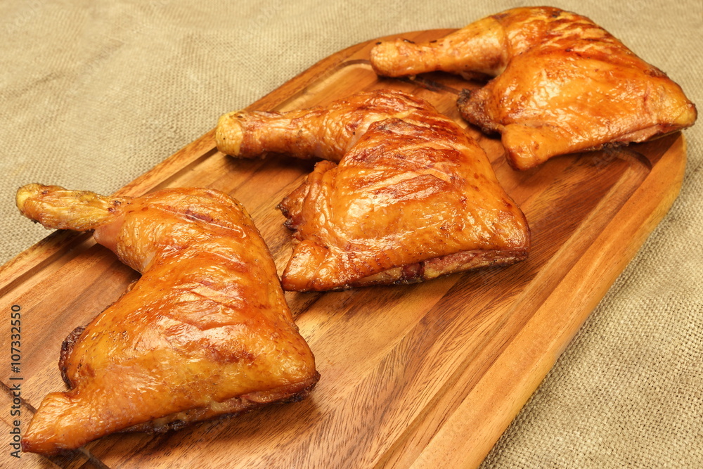 Three Grilled BBQ Chicken Leg Quarter On Wood Board Three Grilled BBQ Chicken Leg Quarter On Wood Board