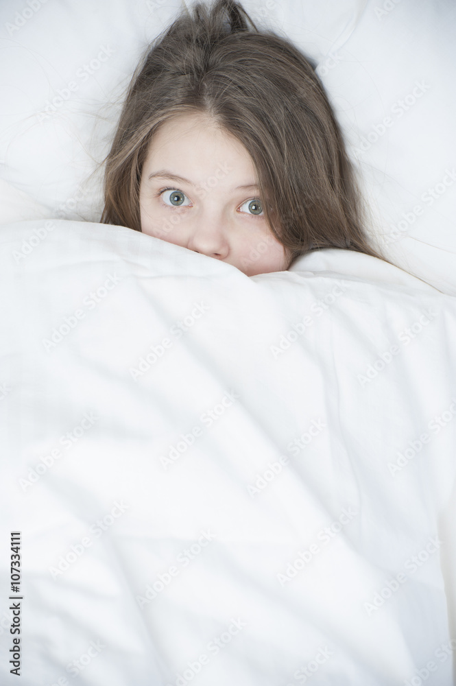 Child looks out from under the blanket.. Child looks out from under the blanket..
