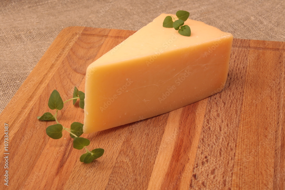 Italian Parmesan cheese with oregano on the wood background