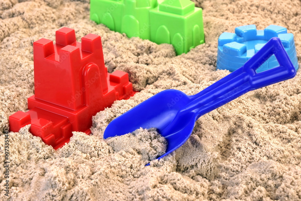 Colored Plastic Shovel And Mold In Sand On The Beach Colored Plastic Shovel And Mold In Sand On The Beach