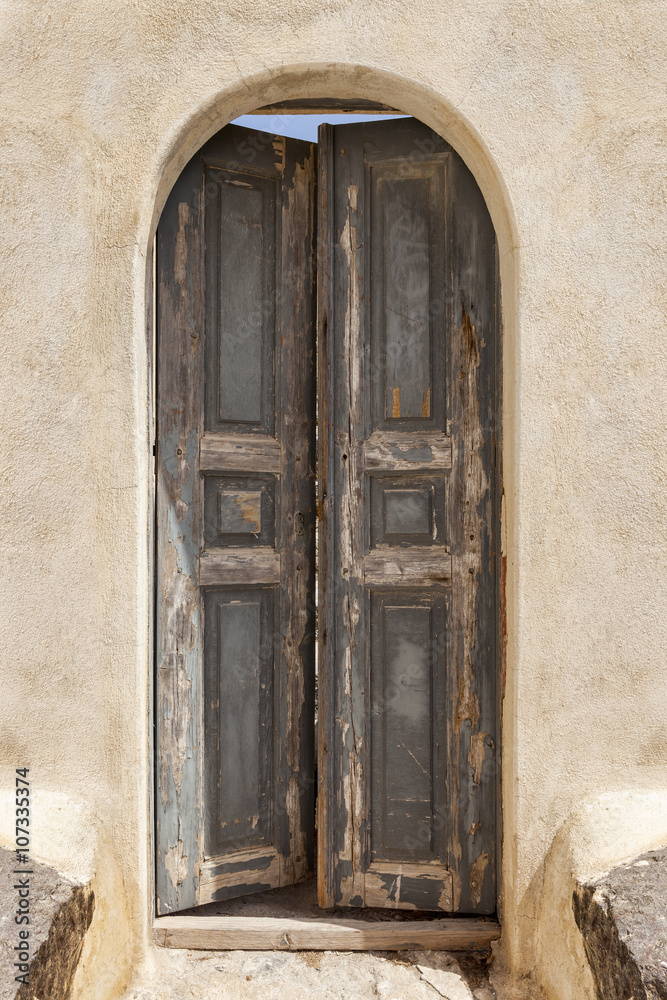 Old wooden door green in Santorini