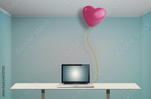 Balloon heart-shaped connected to the laptop with a network cable