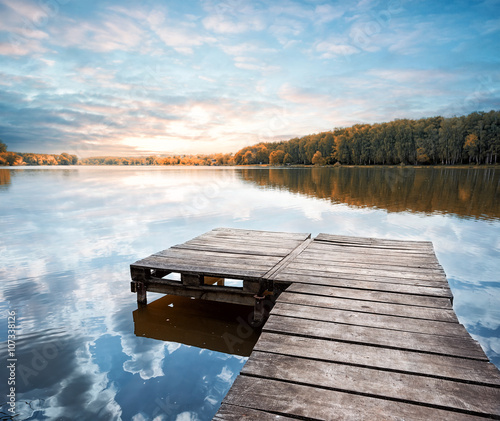 Wooden pier stretching into the lake photo
