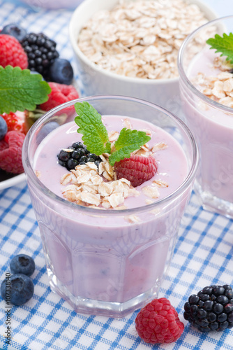 healthy berry smoothies with oatmeal in a glass, vertical