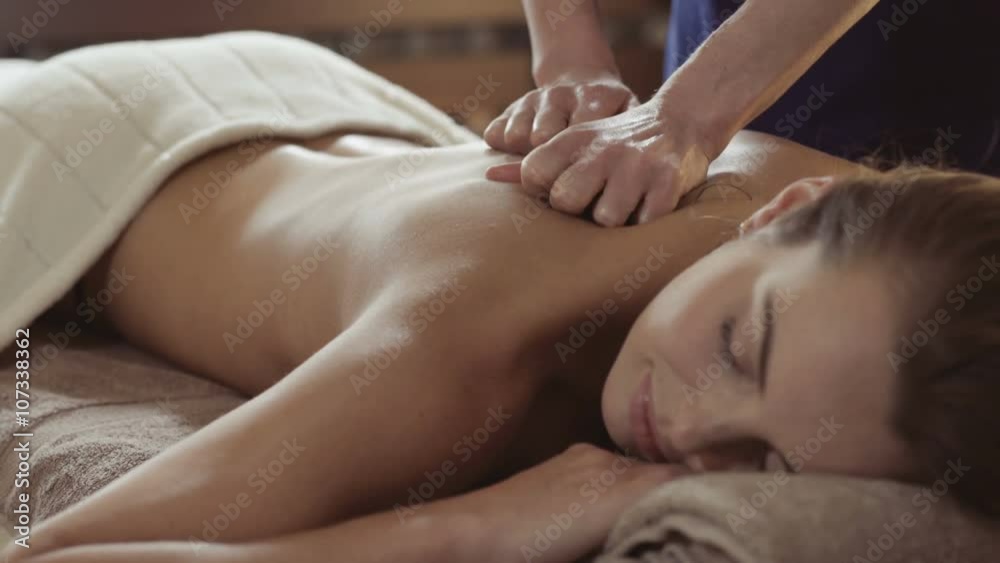 Young woman having a massage in a wellness center Young woman having a massage in a wellness center