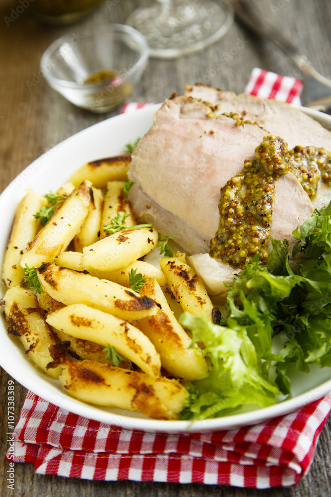 Roasted pork with potato, green salad and mustard