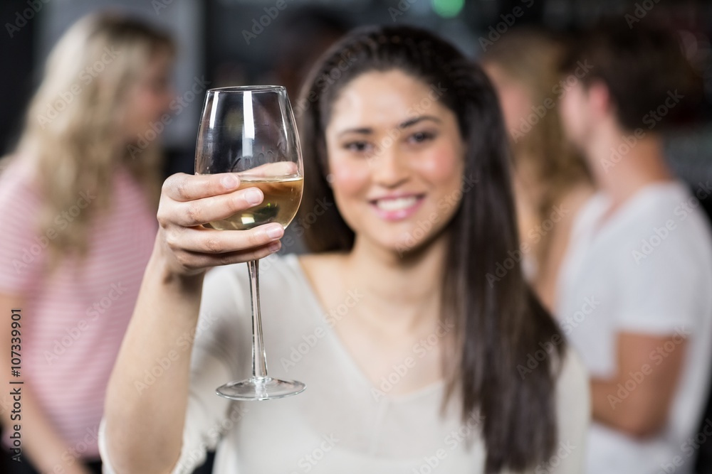 Smiling girl having a glass of wine with her friends Smiling girl having a glass of wine with her friends