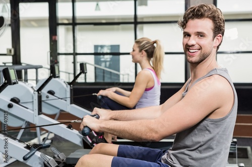 Portrait of man working out on rowing machine