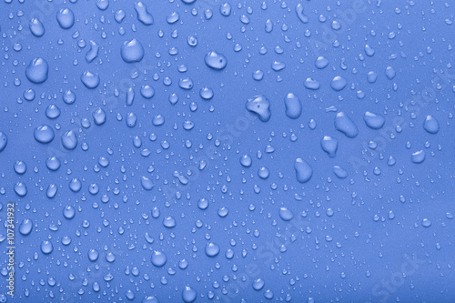 Dops of water on a color background. Blue. Toned