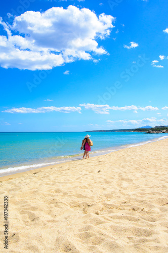 Mother and daughter walking on the beach, tropical sea background