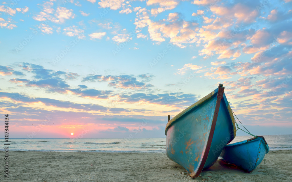sunrise over an wooden fishing boats
