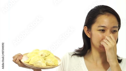 Asian girl can not stand the smell of stinky durian. Smelly fruit of tropical area
