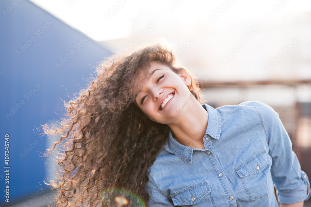 Happy adorable young woman outdoor playing with hair and smilng Happy adorable young woman outdoor playing with hair and smilng
