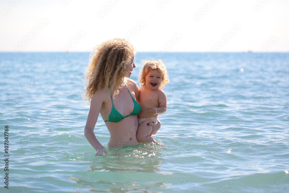 Woman in bikini with child Woman in bikini with child