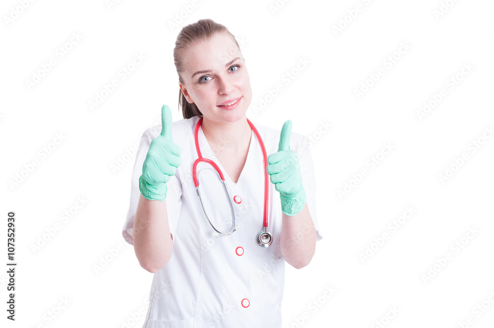 Attractive female doctor giving thumbs up with both hands Attractive female doctor giving thumbs up with both hands