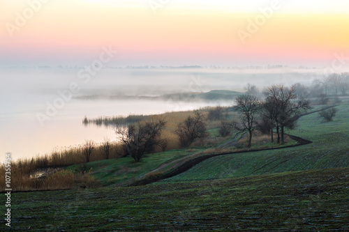 Idyllic Countryside Morning Landscape with Agriculture Field Fog Sunrise