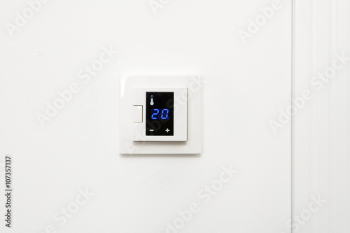 Digital climate control on white wall
