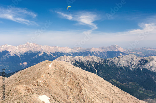 Flying paraglider in the sky on Turkey mountains photo