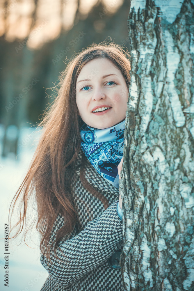 Fototapeta premium Young woman walking stands of birch