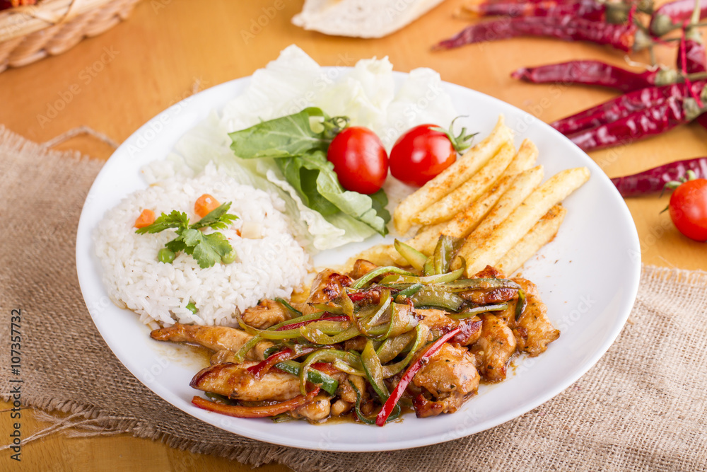 original fajita sizzling smoking Chicken breast with vegetables and sauce decorated with basil leaves original fajita sizzling smoking Chicken breast with vegetables and sauce decorated with basil leaves