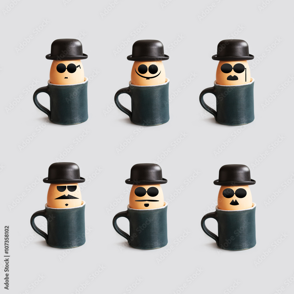 Fotka „Hipster breakfast egg characters with mustache, beard, black bowler  hat and glasses. Creative design holiday poster with eggs and cups. Photo  with drawn gentleman faces vintage style.“ ze služby Stock
