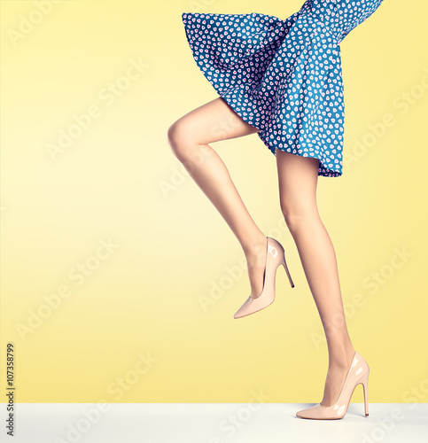 Woman legs in fashion dress and high heels, outfit photo