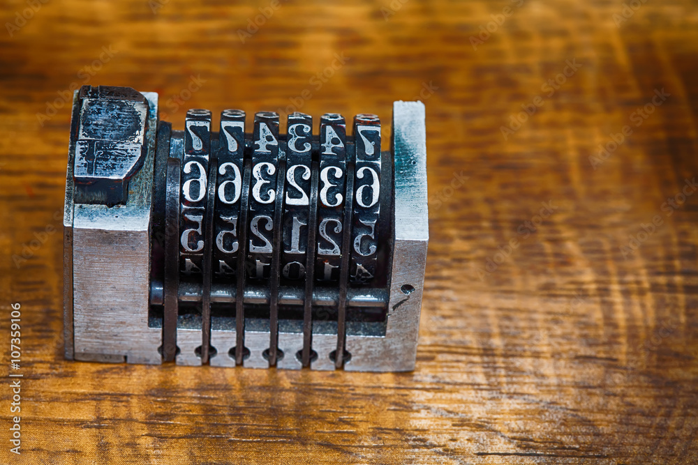 Cliche stamp with numbers Vintage metallic counter mechanism on wood ...