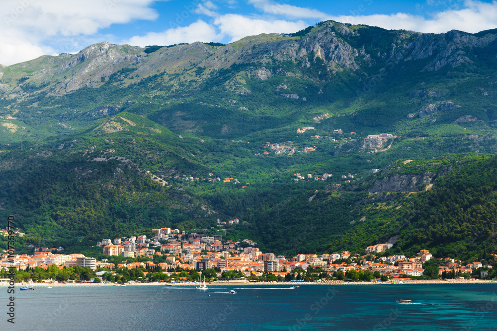 View of the town of Budva, sea bay and mountains distance.