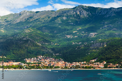 View of the town of Budva, sea bay and mountains distance.