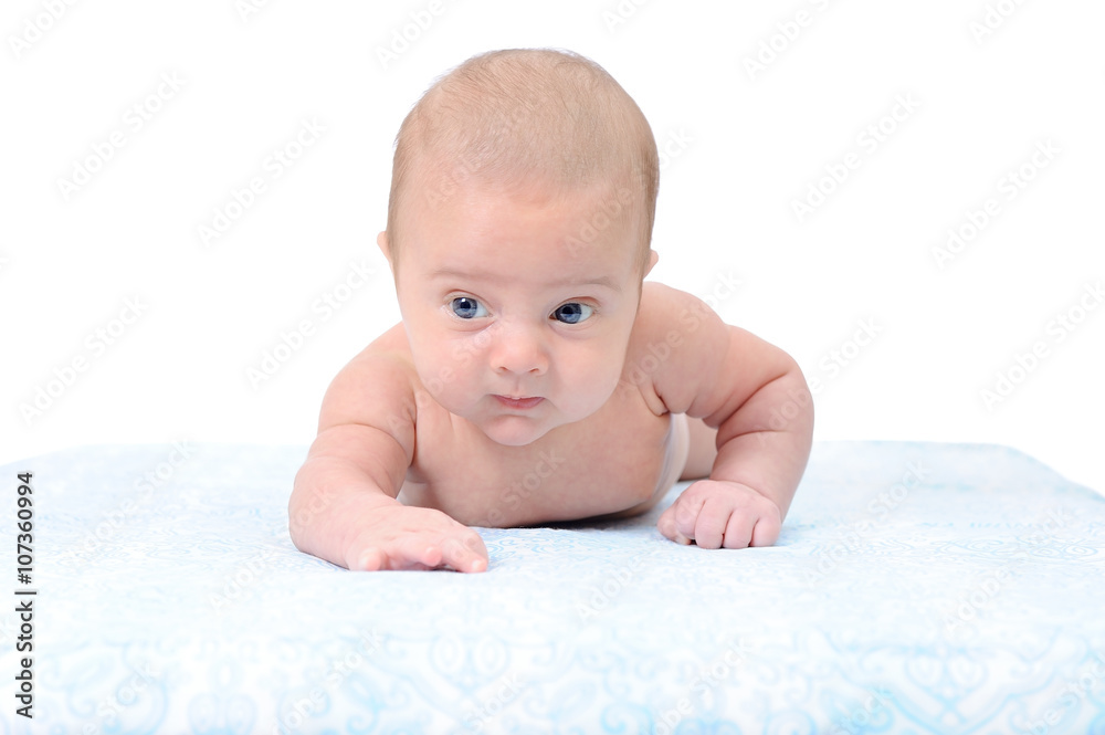Portrait of a Newborn Baby Trying to Crawl on a Blue Blanket