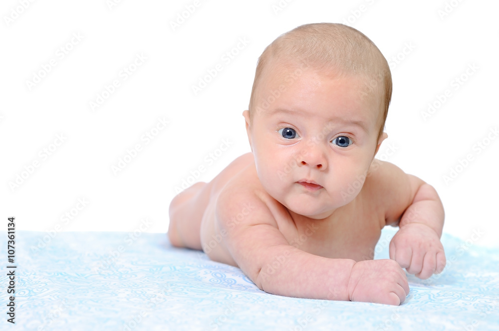 A Newborn Baby Trying to Crawl on a Blue Blanket A Newborn Baby Trying to Crawl on a Blue Blanket