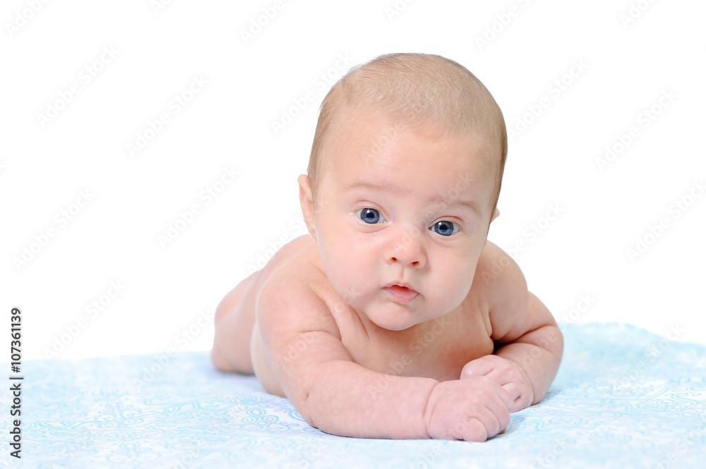 A Newborn Baby Trying to Crawl on a Blue Blanket A Newborn Baby Trying to Crawl on a Blue Blanket