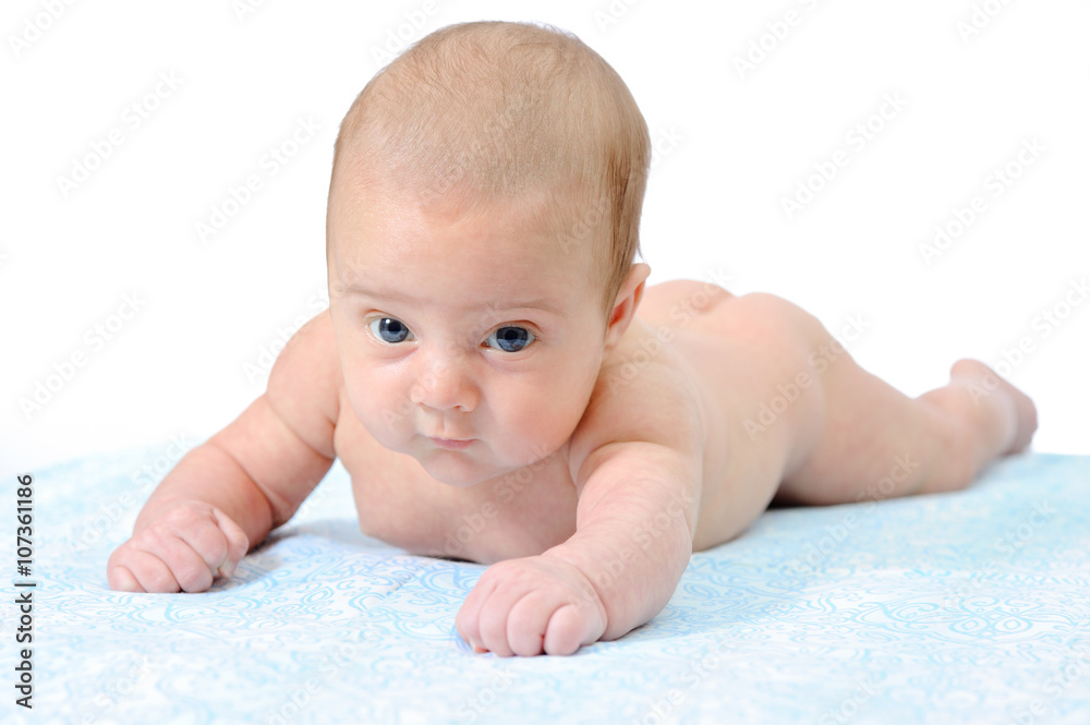 A Newborn Baby Trying to Crawl on a Blue Blanket A Newborn Baby Trying to Crawl on a Blue Blanket