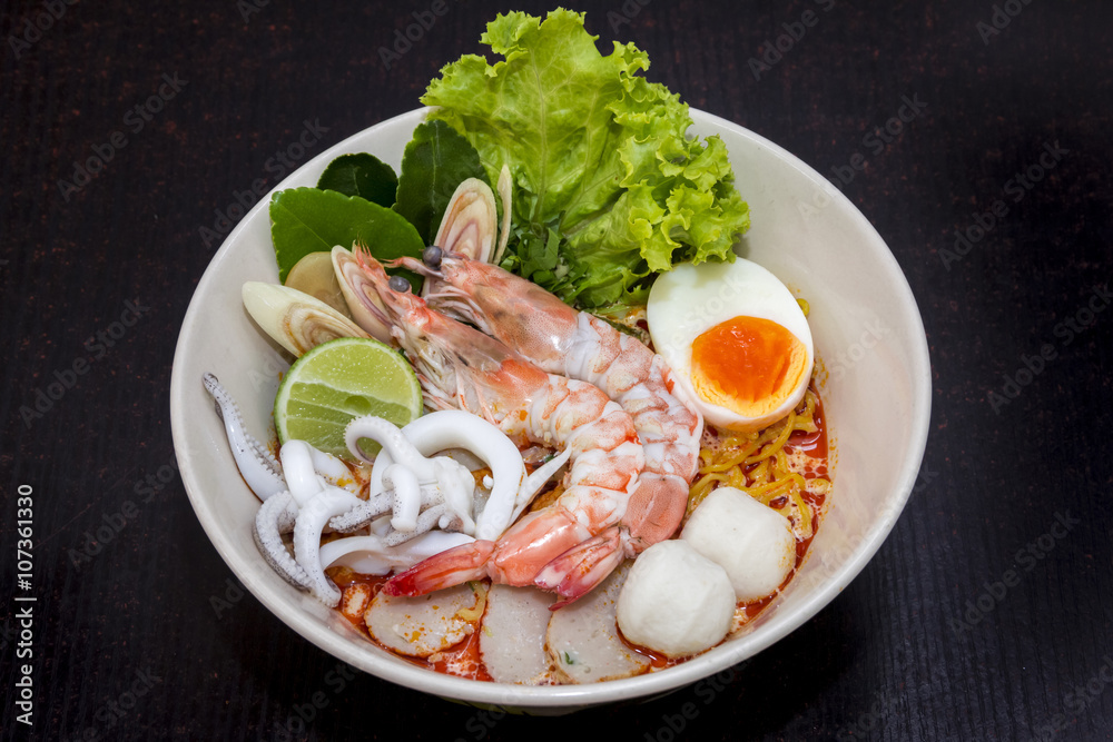 close up. thai noodle seafood, eggs, fish ball in a cup on dark close up. thai noodle seafood, eggs, fish ball in a cup on dark