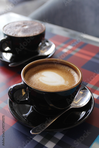 Coffee in black cup on wood table