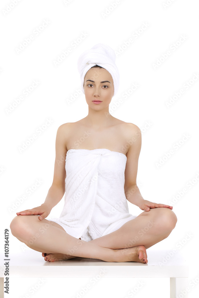 Young woman wrapped towel isolated on white background