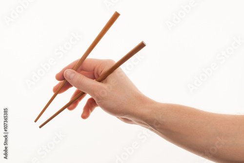 isolated man hand holding wooden chopstick