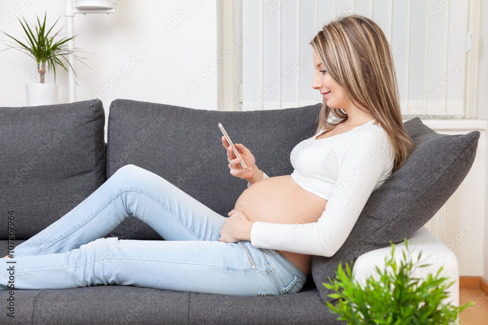 Beautiful pregnant woman relaxing at home Beautiful pregnant woman relaxing at home