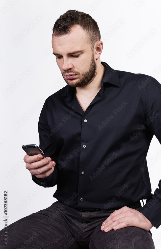 Young handsome man looking at his smartphone Young handsome man looking at his smartphone
