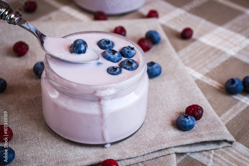 Healthy breakfast - blueberry yogurt with berries on a napkin