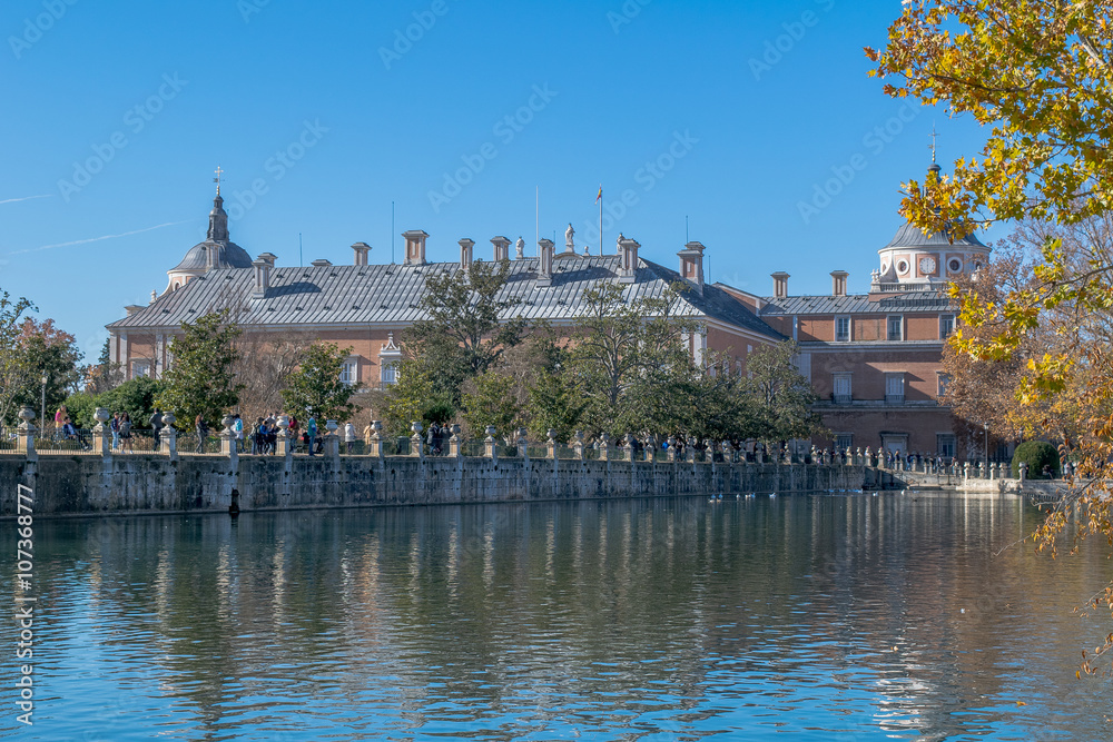 Palace of Aranjuez reflected in the water under a big blue sky