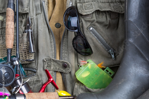 fishing tackles with fishing vest and boots