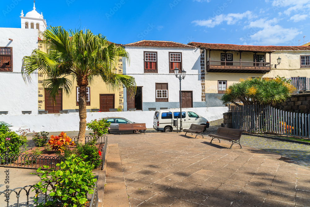 Fototapeta premium Square with tropical plants and typical Canary style buildings in Garachico old town, Tenerife, Canary Islands, Spain