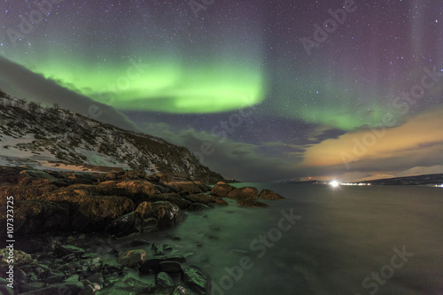 Northern Lights on the icy sea of Svensby, Lyngen Alps, Troms, Lapland