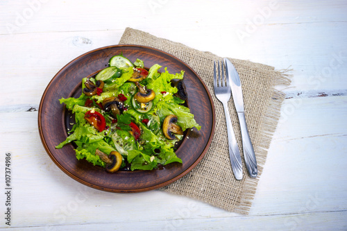 vegetable salad - cold appetizer of fried mushrooms with lettuce and tomatoes