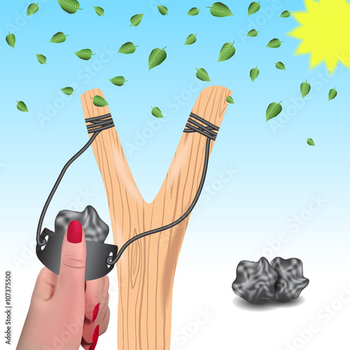 Slingshot against a background of falling leaves.Slingshot in a