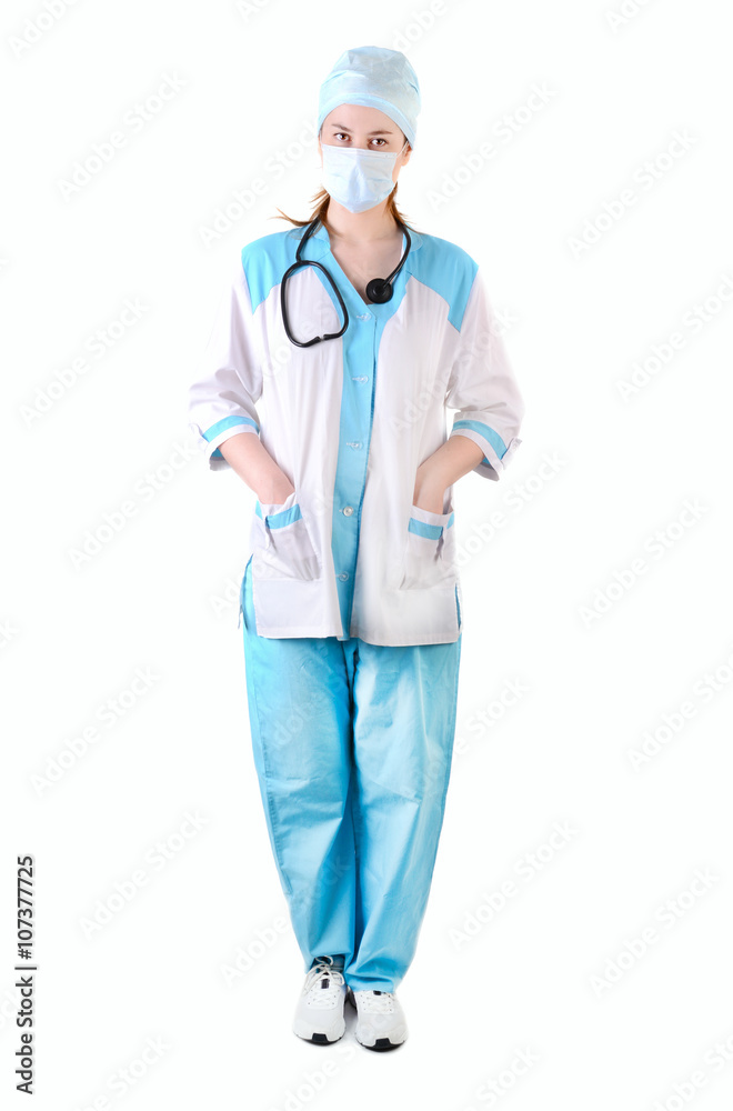 Full length female doctor with medical mask on face with hands in pockets, look at camera , isolated on white backgroun Full length female doctor with medical mask on face with hands in pockets, look at camera , isolated on white backgroun