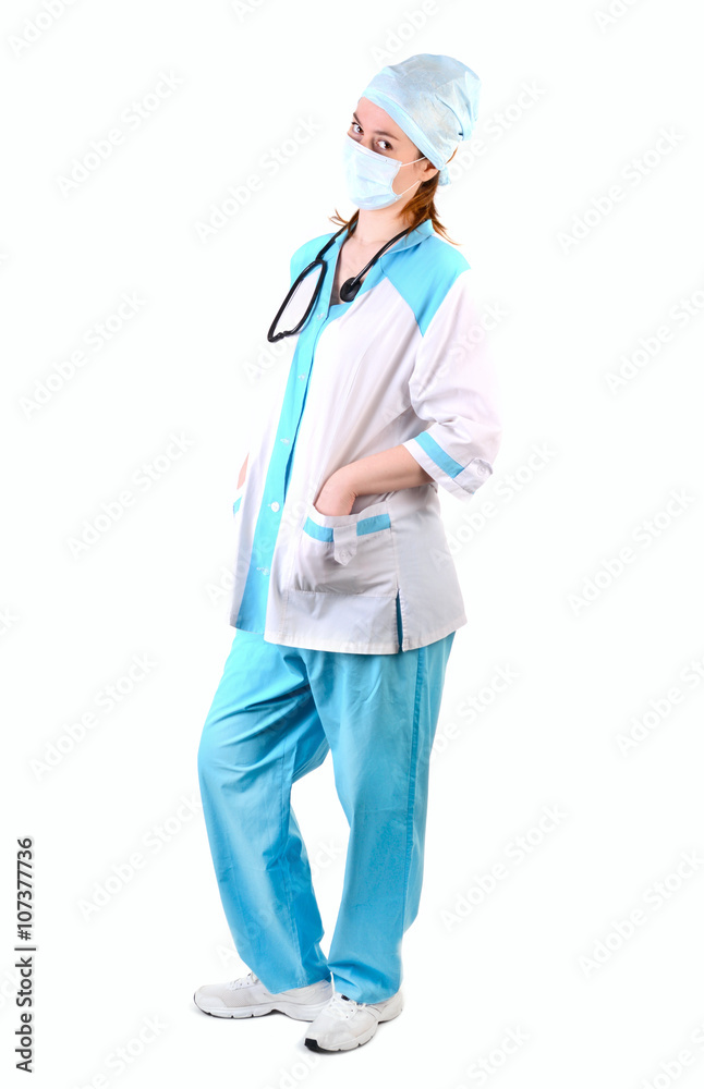 Full length female doctor with medical mask on face with hands in pockets, look at camera , isolated on white background Full length female doctor with medical mask on face with hands in pockets, look at camera , isolated on white background